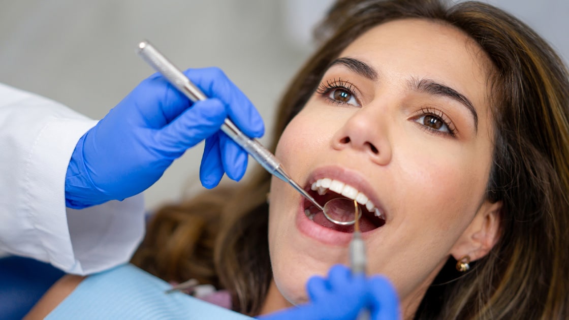 Lady with dark hair in dental procedure